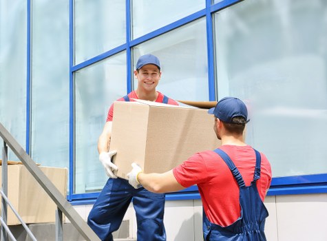 Removal van handling furniture and boxes in a residential Enfieldlock street