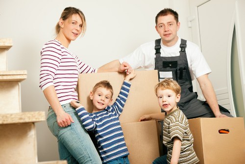 Family moving boxes into a new property in Enfieldlock