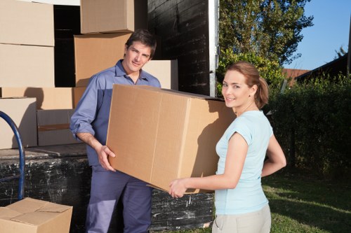 Packed household boxes and furniture ready for collection in Enfieldlock